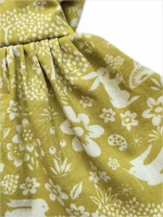 An apron dress with meadow pattern 