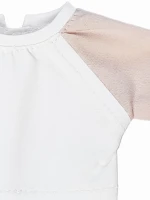 A white raglan shirt with pink sleeves