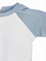 A white raglan shirt with blue sleeves